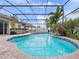 Inviting screened-in pool area with lush tropical landscaping, outdoor bar, and comfortable seating for outdoor entertaining at 826 Jade Forest Ave, Orlando, FL 32828
