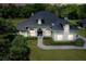 Inviting home featuring manicured landscaping, a gray roof, and arched windows at 878 Cardinal Pointe Cv, Sanford, FL 32771