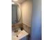 Bathroom vanity featuring a round mirror and stylish decor at 9400 Se 119Th St, Belleview, FL 34420
