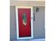 Close-up of the red front door with decorative glass and house number at 9400 Se 119Th St, Belleview, FL 34420