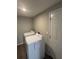 Bright laundry room featuring modern white washer and dryer appliances and white door at 9400 Se 119Th St, Belleview, FL 34420