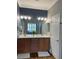 Bathroom with double sink vanity, wood cabinets, and large mirror at 9872 Sw 75Th Street Rd, Ocala, FL 34481