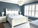 Serene bedroom featuring a white bed frame, ample natural light from shuttered windows, and elegant decor at 9872 Sw 75Th Street Rd, Ocala, FL 34481
