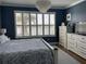 Cozy bedroom features a capiz shell chandelier and a view to the outside at 9872 Sw 75Th Street Rd, Ocala, FL 34481