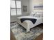 Guest bedroom with white wood bed frame, wood flooring, and shutters at 9872 Sw 75Th Street Rd, Ocala, FL 34481