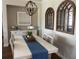 Bright dining room with hardwood floors, white table, and pendant light fixture at 9872 Sw 75Th Street Rd, Ocala, FL 34481