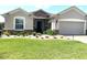 Charming home featuring a stone facade, well-manicured lawn, and a welcoming entrance with beautiful landscaping at 9872 Sw 75Th Street Rd, Ocala, FL 34481