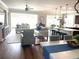 Bright and spacious living room featuring an open-concept design, hardwood floors, and large windows at 9872 Sw 75Th Street Rd, Ocala, FL 34481