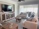 Comfortable living room featuring stylish furnishings, hardwood floors, and a view into the dining area at 9872 Sw 75Th Street Rd, Ocala, FL 34481
