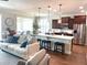 Spacious living area with an open-concept design and seamless flow into the modern kitchen at 9872 Sw 75Th Street Rd, Ocala, FL 34481