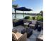 Outdoor patio overlooking the water with comfortable seating and an umbrella at 9872 Sw 75Th Street Rd, Ocala, FL 34481