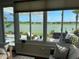 Cozy sunroom with panoramic views of the lake and access to the outdoor patio at 9872 Sw 75Th Street Rd, Ocala, FL 34481