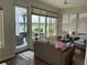 Enclosed sunroom with water view, ceiling fan, and comfortable seating at 9872 Sw 75Th Street Rd, Ocala, FL 34481