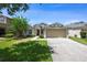 Charming single Gathering home featuring a well-manicured lawn and a two-car garage at 1438 Portmoor Way, Winter Garden, FL 34787