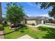 Side view of a well-maintained home with a lush green lawn and mature tree at 1438 Portmoor Way, Winter Garden, FL 34787