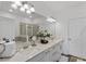 Clean bathroom with double sinks, quartz countertops, and modern vanity lights at 308 Rustic Loop, Sanford, FL 32771
