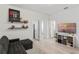 A bedroom with a cozy seating area, a TV, and bright natural light at 308 Rustic Loop, Sanford, FL 32771