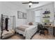 Inviting bedroom featuring a comfortable bed, desk, and decorative touches, perfect for relaxation and productivity at 308 Rustic Loop, Sanford, FL 32771