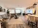 Bright open-concept living room with a cozy sectional and hardwood floors at 308 Rustic Loop, Sanford, FL 32771