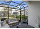 Enclosed patio offering an outdoor living space with comfortable seating and a view of the surrounding neighborhood at 308 Rustic Loop, Sanford, FL 32771