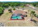 Aerial view of the backyard with pool, patio, and well maintained yard at 32510 Wolf Branch Ln, Sorrento, FL 32776