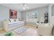 Cozy bedroom with a daybed, white furnishings, neutral rug, and an abundance of natural light at 32510 Wolf Branch Ln, Sorrento, FL 32776