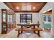 Elegant dining room with wood table, china cabinet, and pool view at 32510 Wolf Branch Ln, Sorrento, FL 32776
