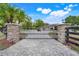 Elegant gated entrance with brick pillars and secure black metal gate at 32510 Wolf Branch Ln, Sorrento, FL 32776