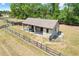 Aerial view of a horse barn on a well manicured and fenced in lot at 32510 Wolf Branch Ln, Sorrento, FL 32776