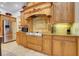 Gourmet kitchen with custom wood cabinetry, stainless steel appliances, and tile backsplash at 32510 Wolf Branch Ln, Sorrento, FL 32776