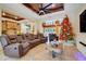 Comfortable living room with entertainment center, wood ceiling, and a Christmas tree near open concept kitchen at 32510 Wolf Branch Ln, Sorrento, FL 32776