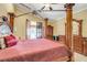 Spacious main bedroom featuring a four-poster bed, wood ceiling, and access to the backyard at 32510 Wolf Branch Ln, Sorrento, FL 32776