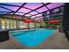 Screened-in pool area with an in-ground pool, patio furniture, and overhead string lights at 32510 Wolf Branch Ln, Sorrento, FL 32776
