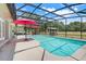 Inviting screened-in pool area with outdoor seating and lush landscaping at 32510 Wolf Branch Ln, Sorrento, FL 32776