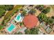Stunning aerial view of community clubhouse, pools, tennis courts, and lush landscaping at 516 Bahia Cir # B, Ocala, FL 34472