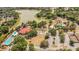 Aerial view of community amenities including a pool, tennis courts and a lake at 516 Bahia Cir # B, Ocala, FL 34472
