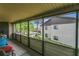 View from the screened-in balcony overlooking the well-maintained landscaping at 516 Bahia Cir # B, Ocala, FL 34472