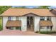 Inviting exterior view of a two-story condo building with brown roofing and well-maintained landscaping at 516 Bahia Cir # B, Ocala, FL 34472