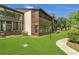Exterior view of the property featuring lush greenery, manicured lawn, and charming architectural details at 516 Bahia Cir # B, Ocala, FL 34472