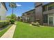 Beautiful exterior showcasing a condo building with lush landscaping and a walkway at 516 Bahia Cir # B, Ocala, FL 34472