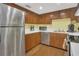 Functional kitchen featuring stainless steel appliances and wood cabinets at 516 Bahia Cir # B, Ocala, FL 34472