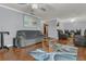 Comfortable living room with hardwood floors, sofa, recliners, and ceiling fan at 516 Bahia Cir # B, Ocala, FL 34472