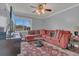 Living room with a vibrant red sectional sofa, patterned rug and natural light at 516 Bahia Cir # B, Ocala, FL 34472