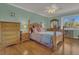 Relaxing main bedroom with a wooden bed frame, wood floors and ample lighting at 516 Bahia Cir # B, Ocala, FL 34472