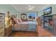 Main bedroom with light green walls, wood floors, and a ceiling fan with light at 516 Bahia Cir # B, Ocala, FL 34472
