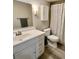 Updated bathroom with modern vanity, framed mirror, decorative cabinet, and tiled shower with a curtain at 516 Polaris Loop # 110, Casselberry, FL 32707