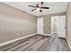 Spacious bedroom featuring wood-look floors, ceiling fan, and convenient access to a walk-in closet at 516 Polaris Loop # 110, Casselberry, FL 32707
