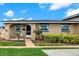 Charming single-story home with a cozy front porch and lush green landscaping at 516 Polaris Loop # 110, Casselberry, FL 32707