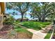 Exterior lawn view showcasing lush trees and manicured green space at 516 Polaris Loop # 110, Casselberry, FL 32707