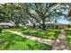 Exterior lawn view showcasing lush trees and manicured green space at 516 Polaris Loop # 110, Casselberry, FL 32707